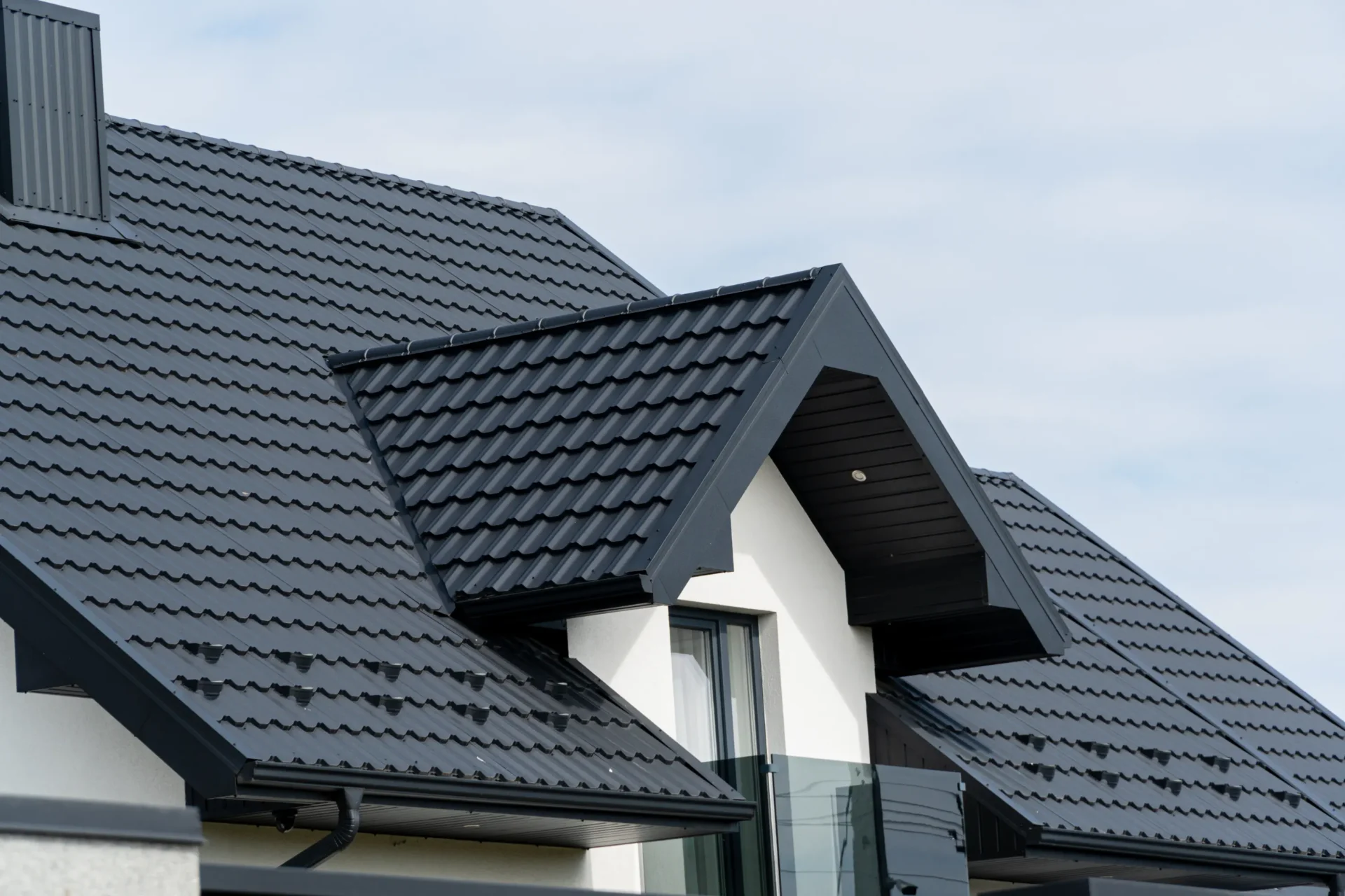 A black roof with white trim and windows.