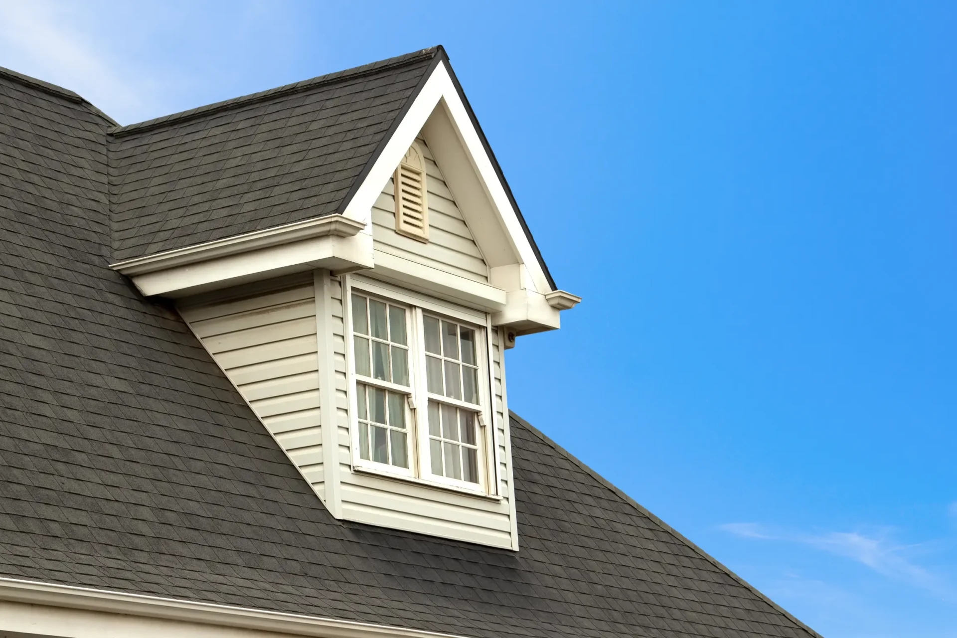 A house with a roof that has been painted white.